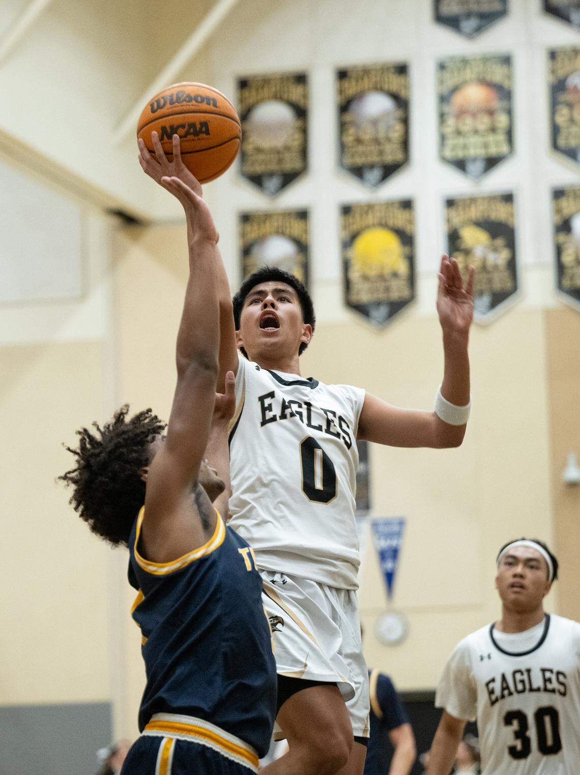 Enochs’ Joseph Ponteras scores over Turlock defender Josiah Simmons during the Central California Athletic League game at Enochs High School in Modesto, Wednesday, Jan. 15, 2025.