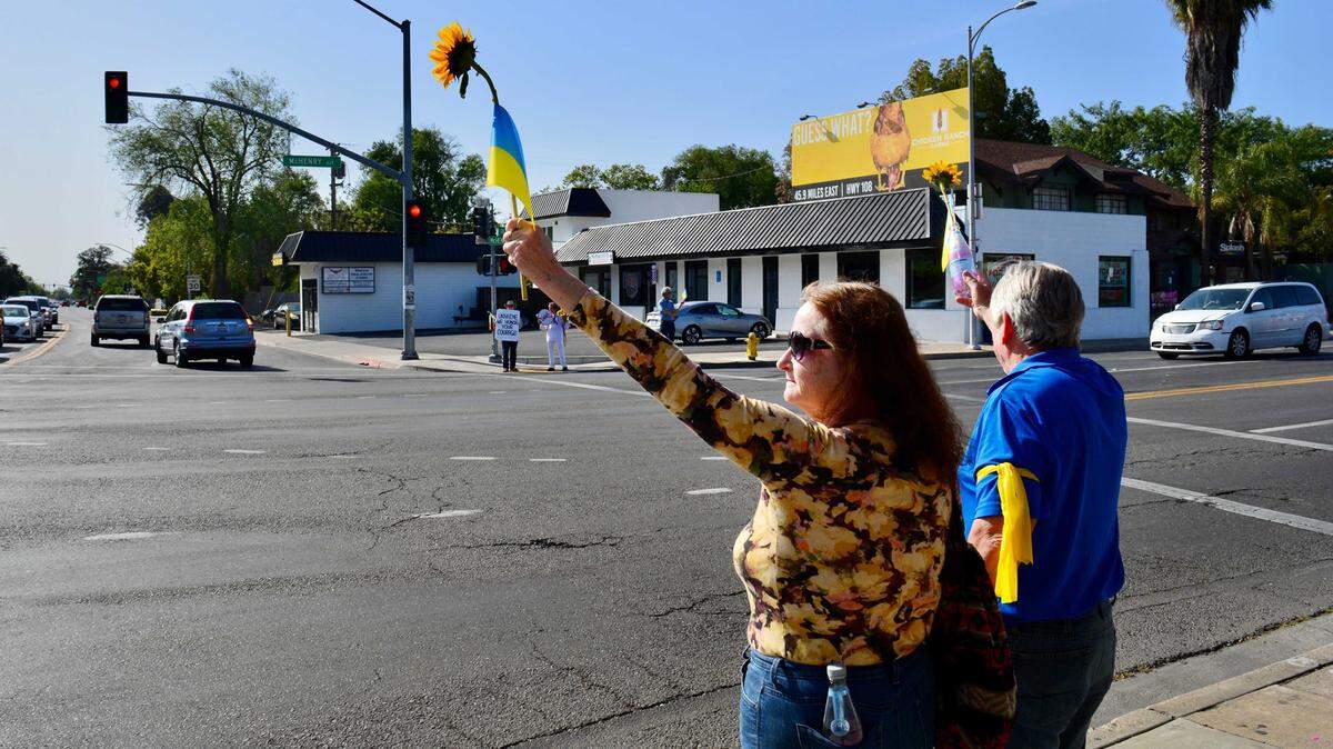 About 50 people gathered at the Five Points intersection for a vigil organized by the Modesto Peace/Life Center.