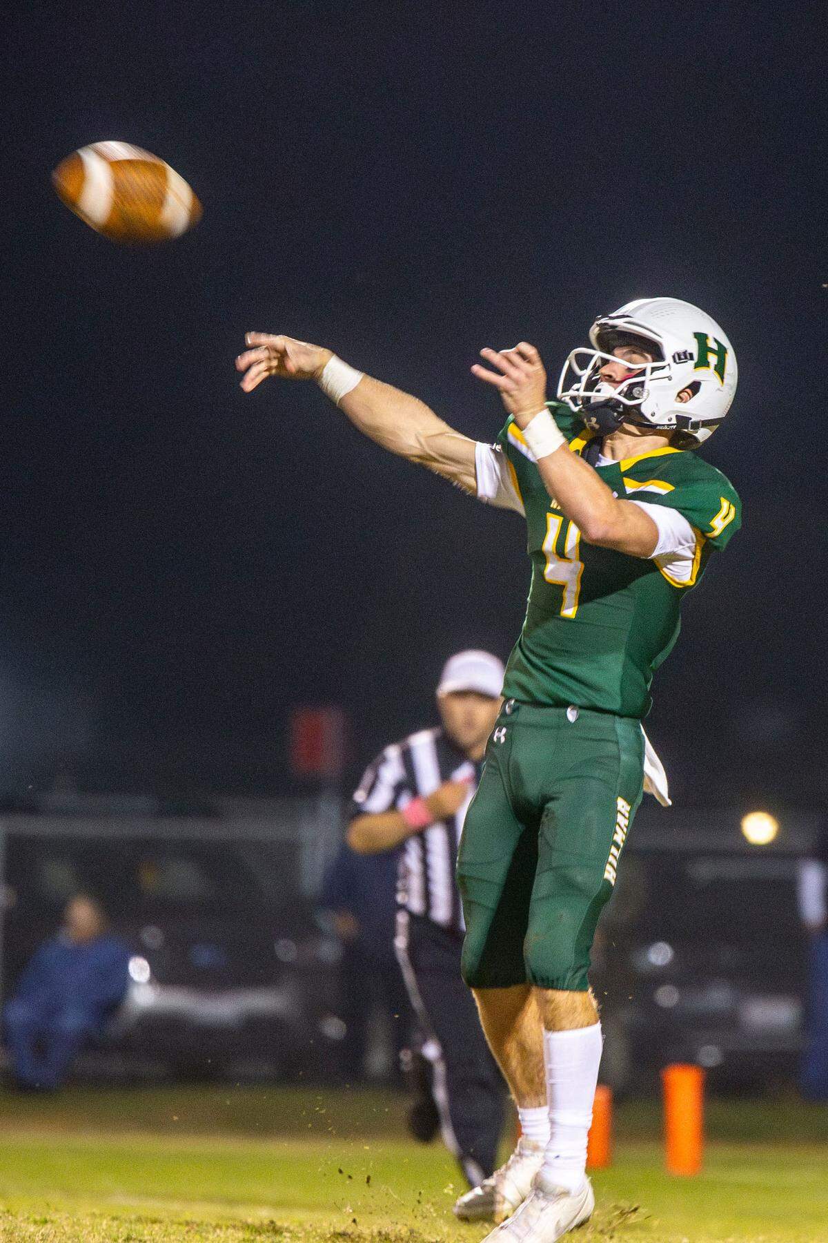 Merek Ellerd, 4, of Hilmar High throws a pass up field during the Trans-Valley League game against Hughson in Hilmar Friday Oct. 25, 2024.