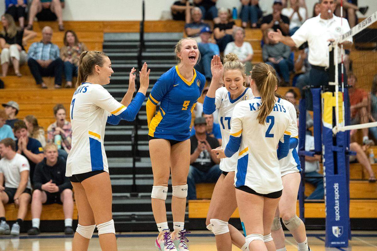 Ripon Christian’s Leah Van Wyngarden (9), Olivia Ozenbaugh (17), Eva Benedict (2) and Jordan Vander Veen (7) celebrate a winning rally during the Southern League game with Mariposa in Ripon, Calif., Thursday, Oct. 13, 2022. Ripon Christian won the match 3-0.