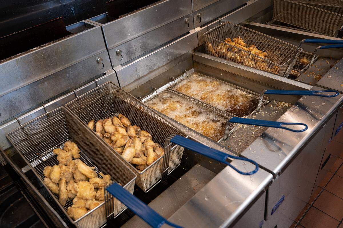 Chicken wings are fried at Fire Wings restaurant in Turlock, Calif., on Thursday, June 9, 2022.