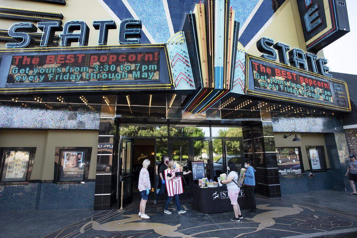 Members of the board of directors sell popcorn at the State Theatre in Modesto, Calif., on Friday, May 1, 2020.