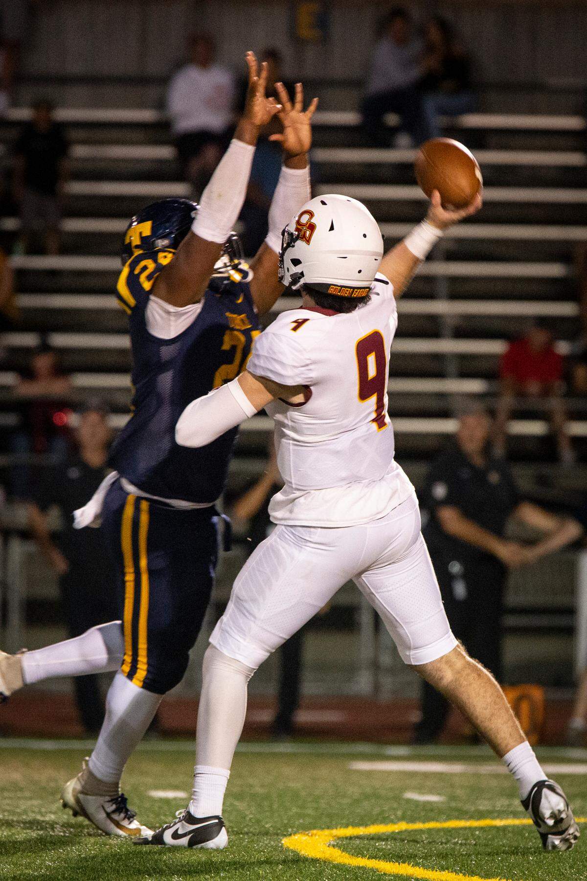 Tarell Johnson (24) of Turlock High pressures Clovis West quarterback Tyler Patrick (9) on Friday night in Turlock