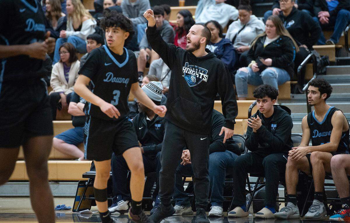 Downey coach Mitch Evans directs his players during the Central California Athletic League with Downey at Enochs High School in Modesto, Calif., Friday, Jan. 27, 2023.