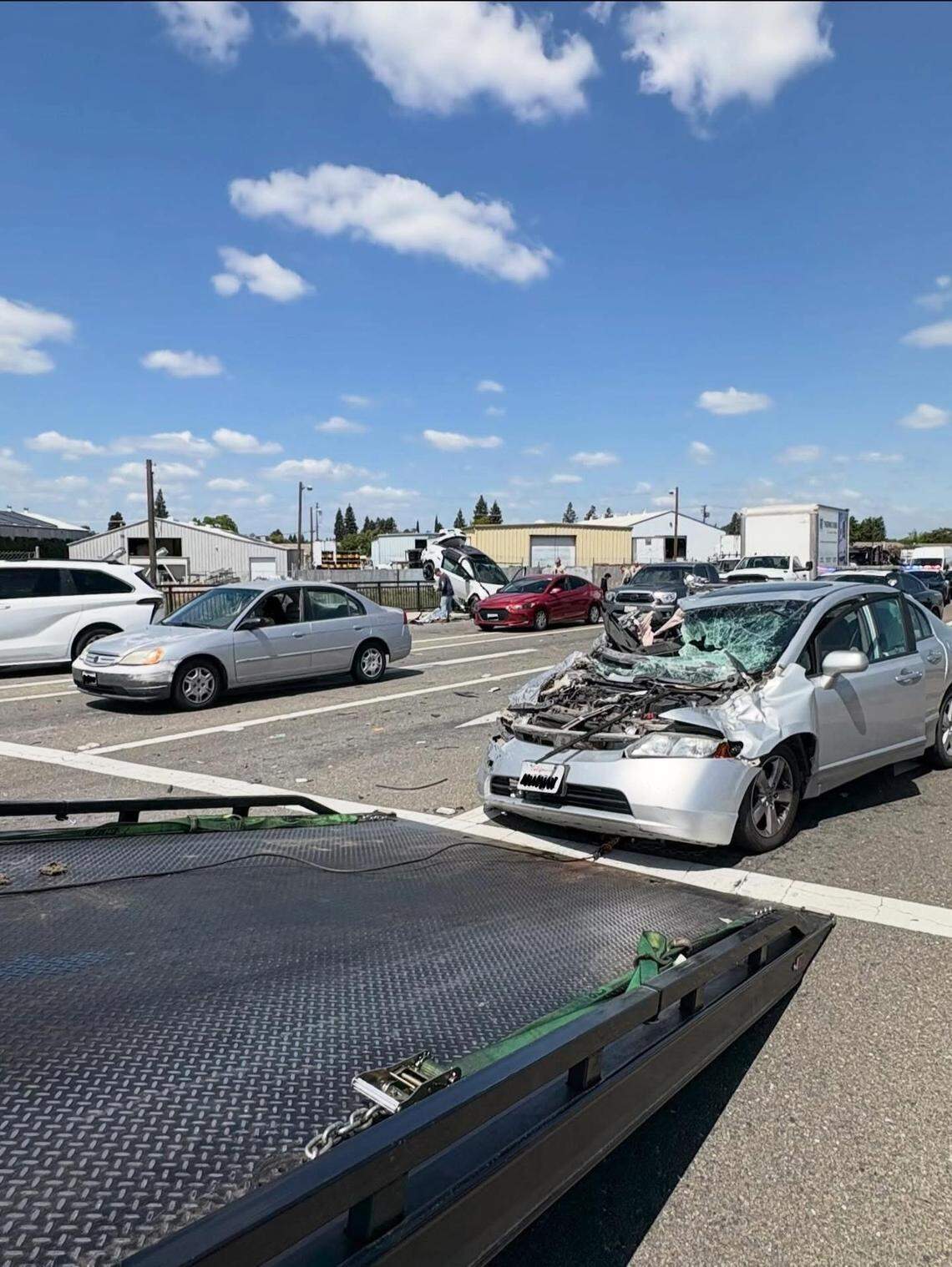 A 2008 Honda Civic sits with heavy front-end damage after being struck by a Toyota Camry at the Highway 99 and Kiernan Avenue interchange Monday afternoon, according to the California Highway Patrol.