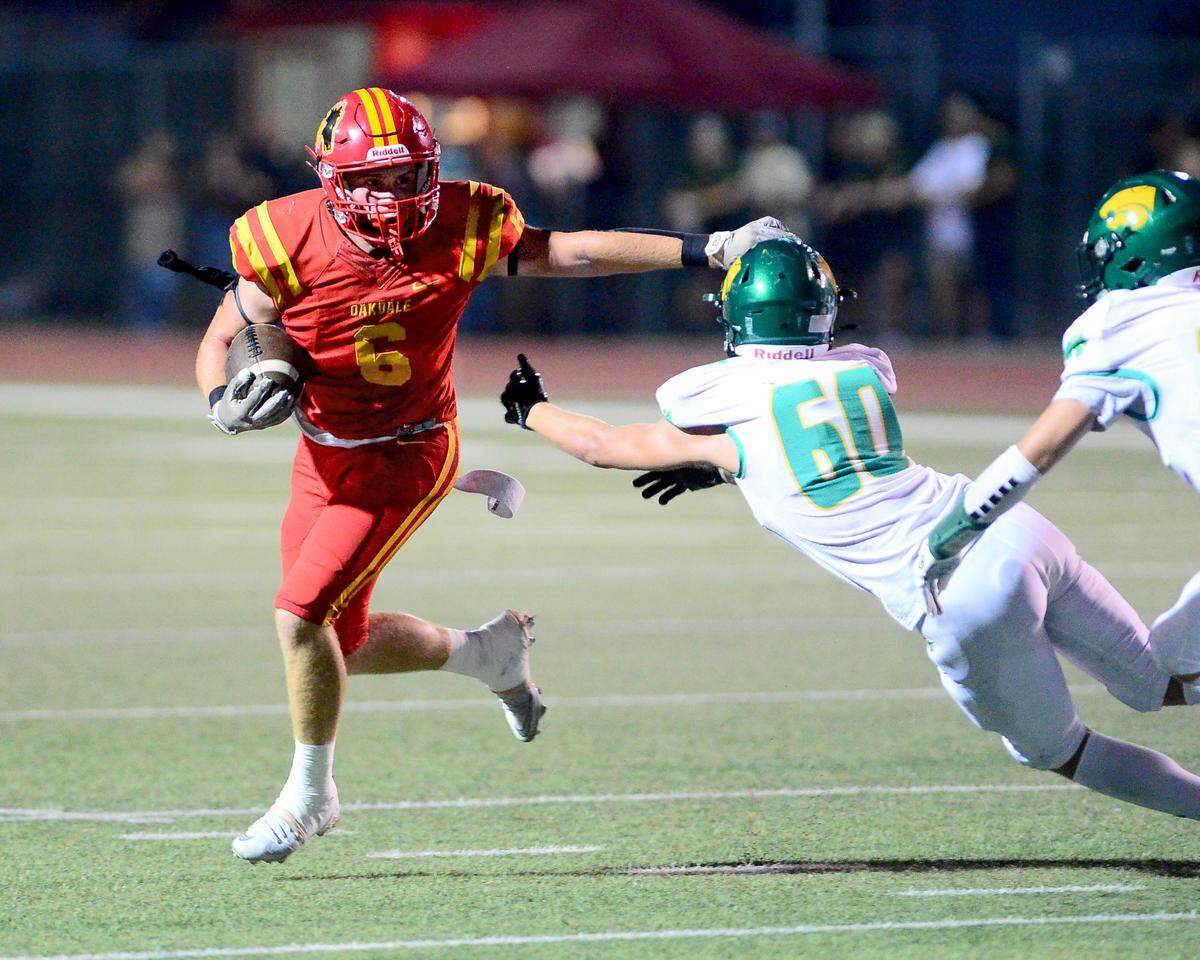 Oakdale running back Chase Lopez (6) dodges a Sonora defender during a game between Oakdale  and Sonora high schools at Oakdale High on Friday, Aug. 22, 2025.