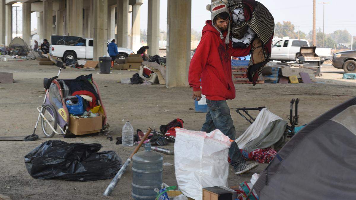 Jorge Corona prepares to move out of a homeless camp of about 50 to 75 people living under the Golden State Blvd overpass in southwest Turlock. Calif. on Thursday November 15, 2018.
