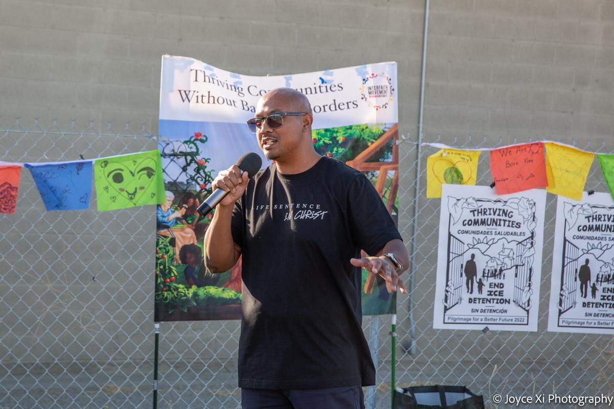 Former inmate Sithy Bin of Modesto addresses people attending the Pilgrimage for a Better Future, an interfaith tour of ICE detention centers, outside the Mesa Verde ICE Processing Center in Bakersfield on May 29, 2022.