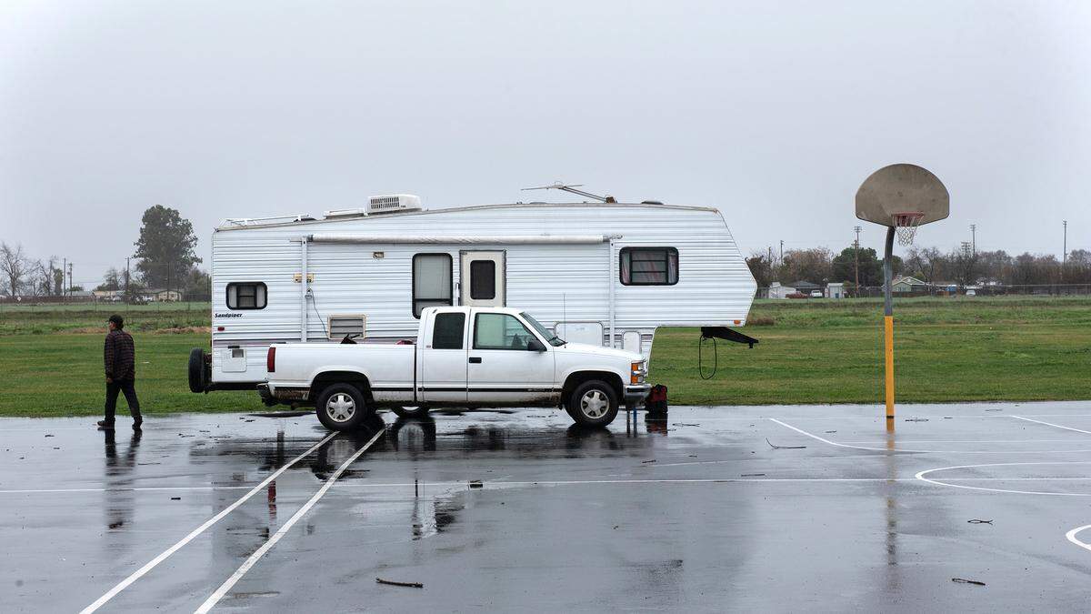 Residents from the evacuation zone along the San Joaquin River were moving their trailers to Yolo Middle School to wait out the storm in Newman, Calif., Wednesday, Jan. 11, 2023. George Almeda was one of the first to arrive after relocating from Fisherman’s Bend RV campground.