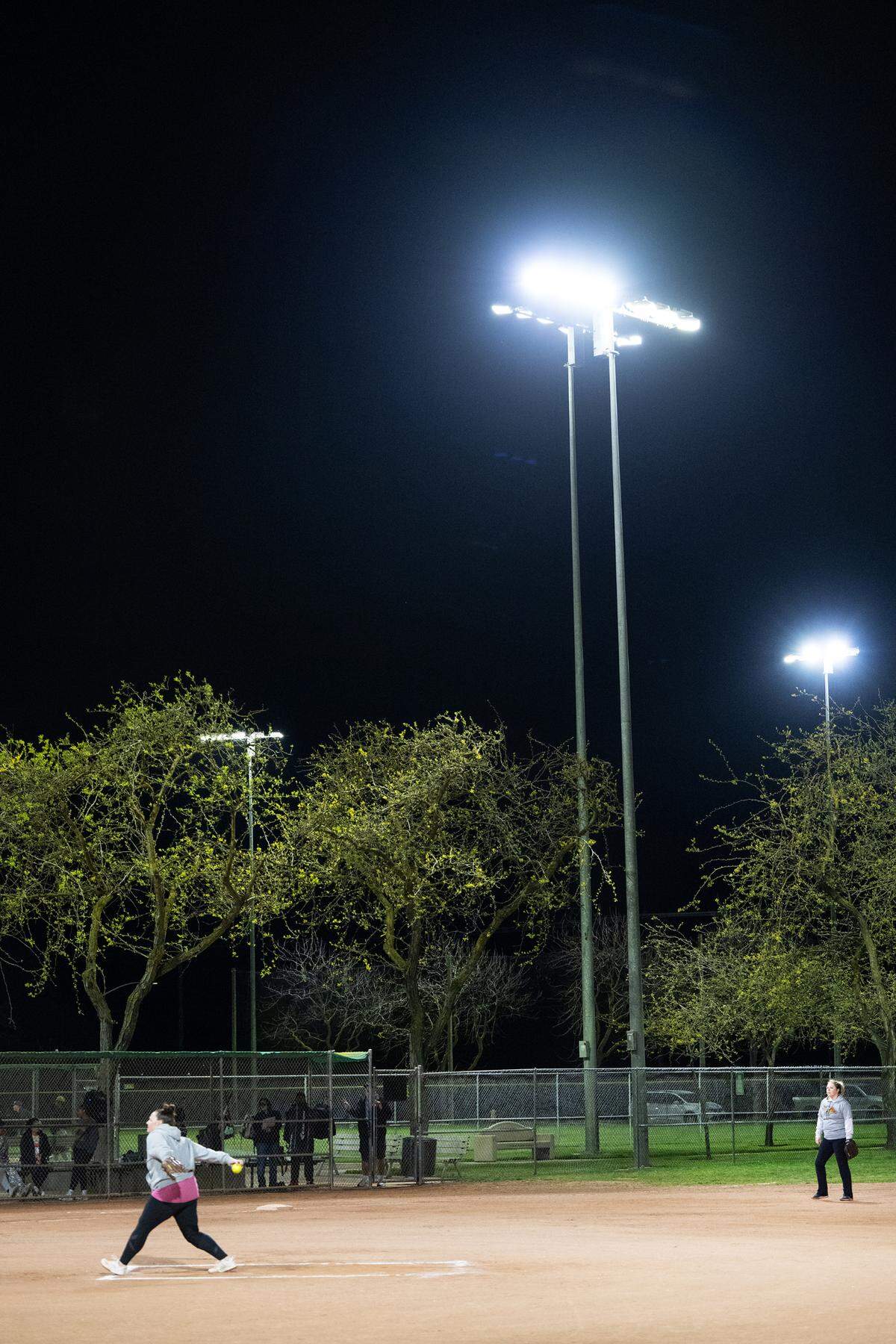 Adults play in a co-ed softball league under new LED lights at Pedretti Park in Turlock, Calif., Thursday, March 28, 2024.