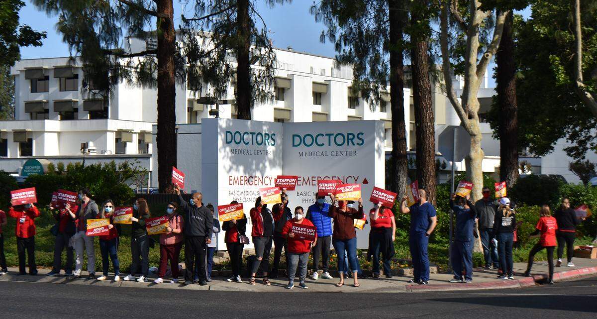 Nurses rally along Orangeburg Avenue in front of Doctors Medical Center on Wednesday, April 27, 2022, to share the message that understaffing isn’t safe for patients. A music system played a steady stream of songs, including at one point “Bad Medicine” by Bon Jovi.