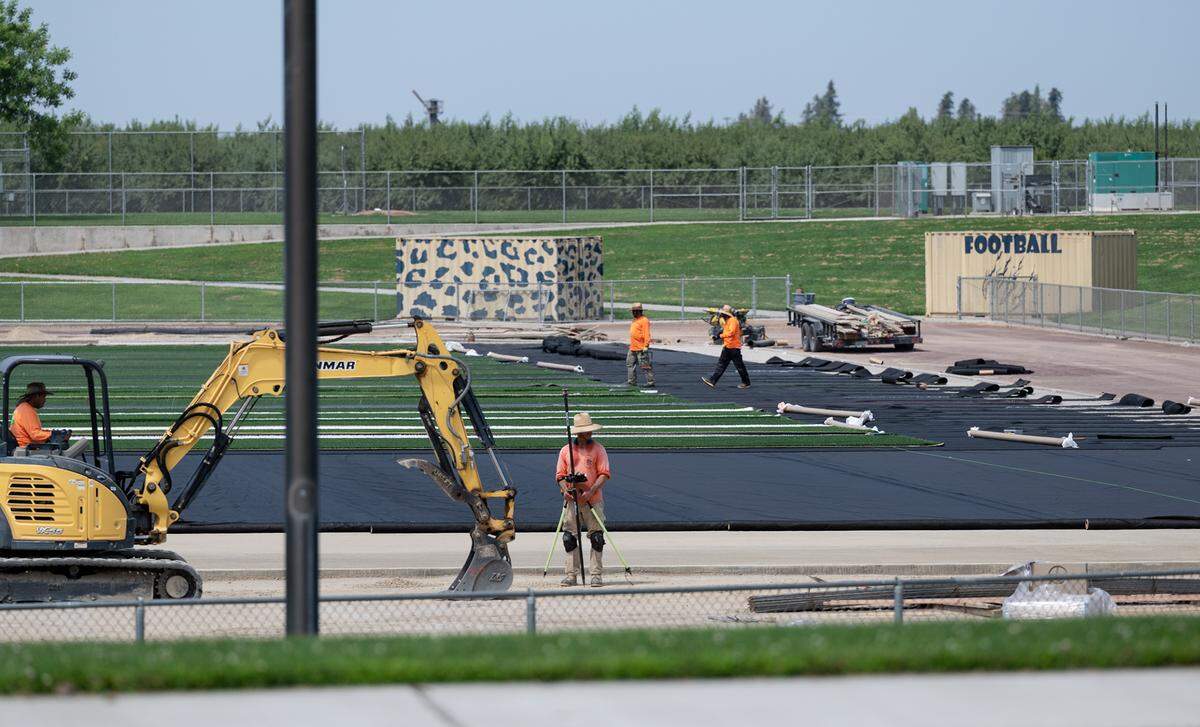 A crew began the installation of the stadium artificial turf at Gregori High School in Salida, Calif., on Friday, July 22, 2022.
