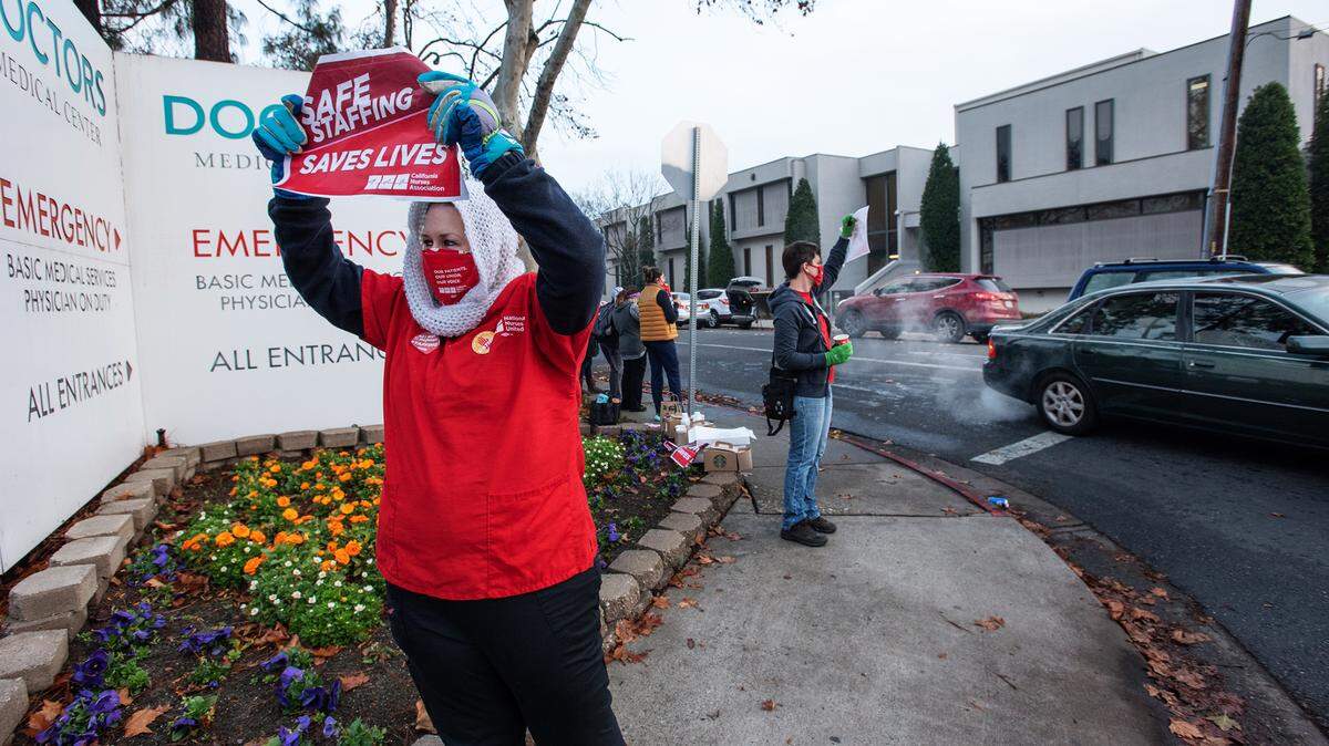 Krystyne Dickerson and other nurses protest emergency staffing ratios outside Doctors Medical Center in Modesto, Calif., Wednesday, Dec. 23, 2020.