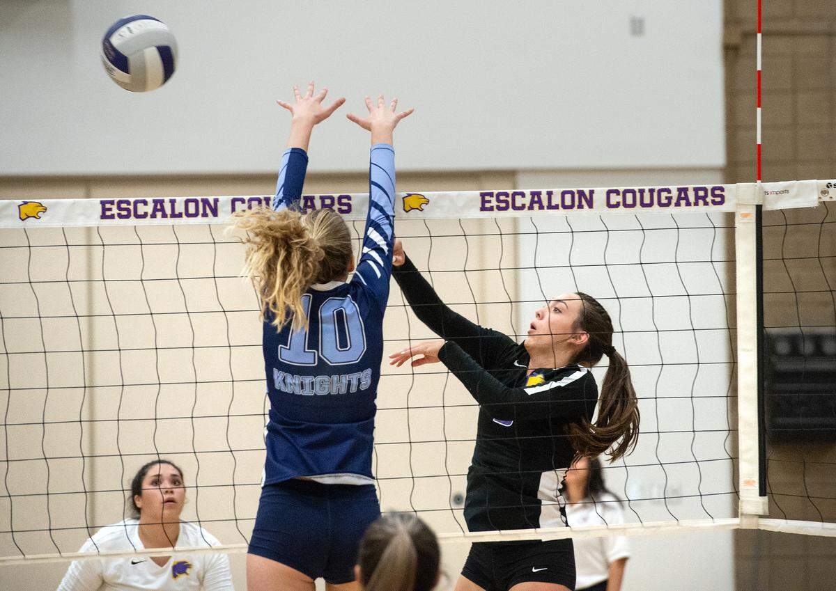 Escalon’s Emily Vickers spikes the ball cross-court past Downey’s Kylie Griffin during a non-league match in Escalon, Calif., on Tuesday, September 27, 2022.