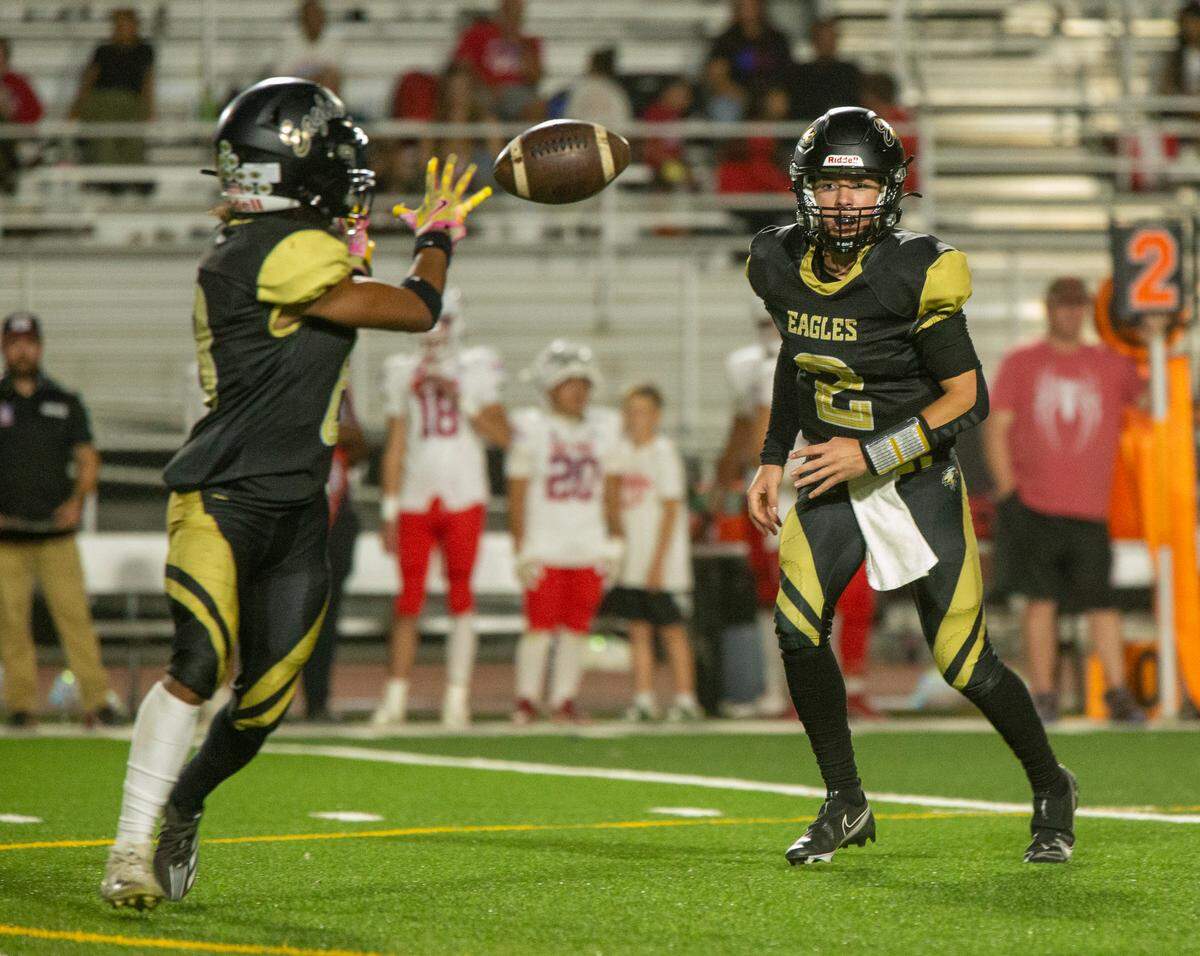 Johnny Staggs, 2, of Enochs High , tosses the ball to Eric Myles, 8, as they work their way upfield against East Union Friday Sept. 13, 2024.  