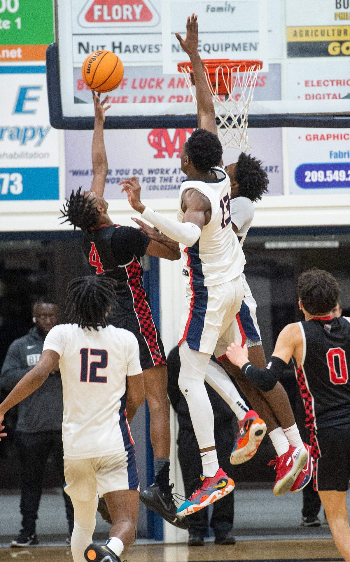 Modesto Christian’s Prince Oseya blocks the shot of Lincoln’s Anthony Moore during the Sac-Joaquin Section Division I playoff game at Modesto Christian High School in Salida, Calif., Friday, Feb. 17, 2023.