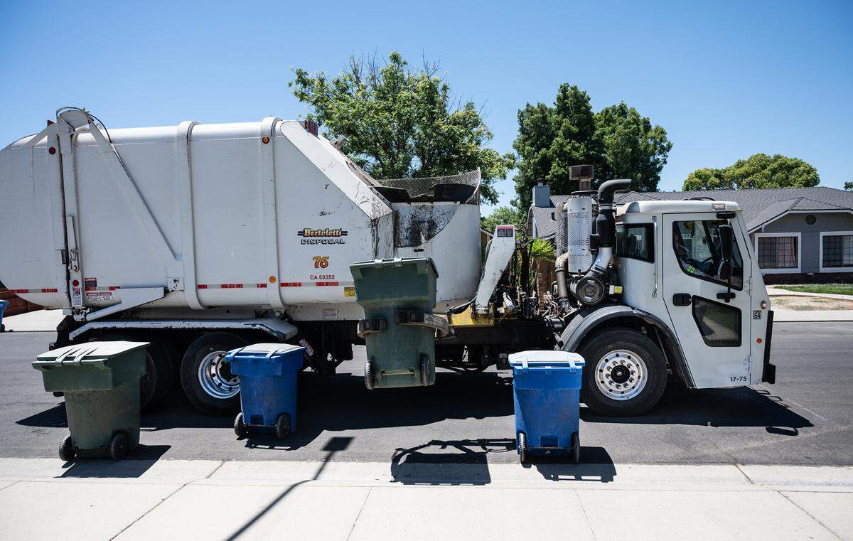 A Bertolotti disposal truck collects garbage in Ceres, Calif., on Tuesday, June 22, 2021.