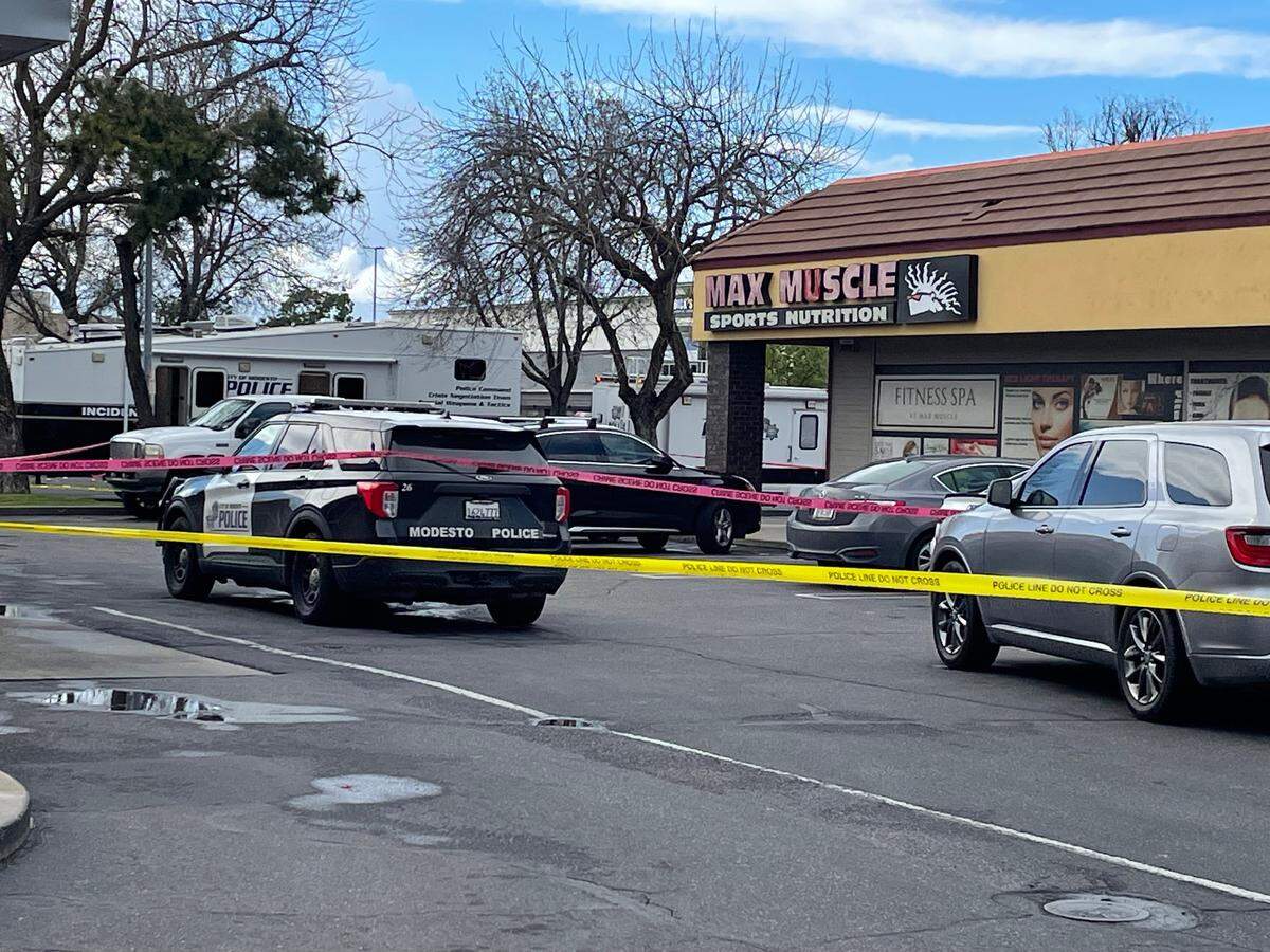 Police crime scene tape blocks access to Max Muscle on the 3200 block of Dale Road as Modesto Police Department investigates a shooting involving police and a suspect on March 17, 2025.