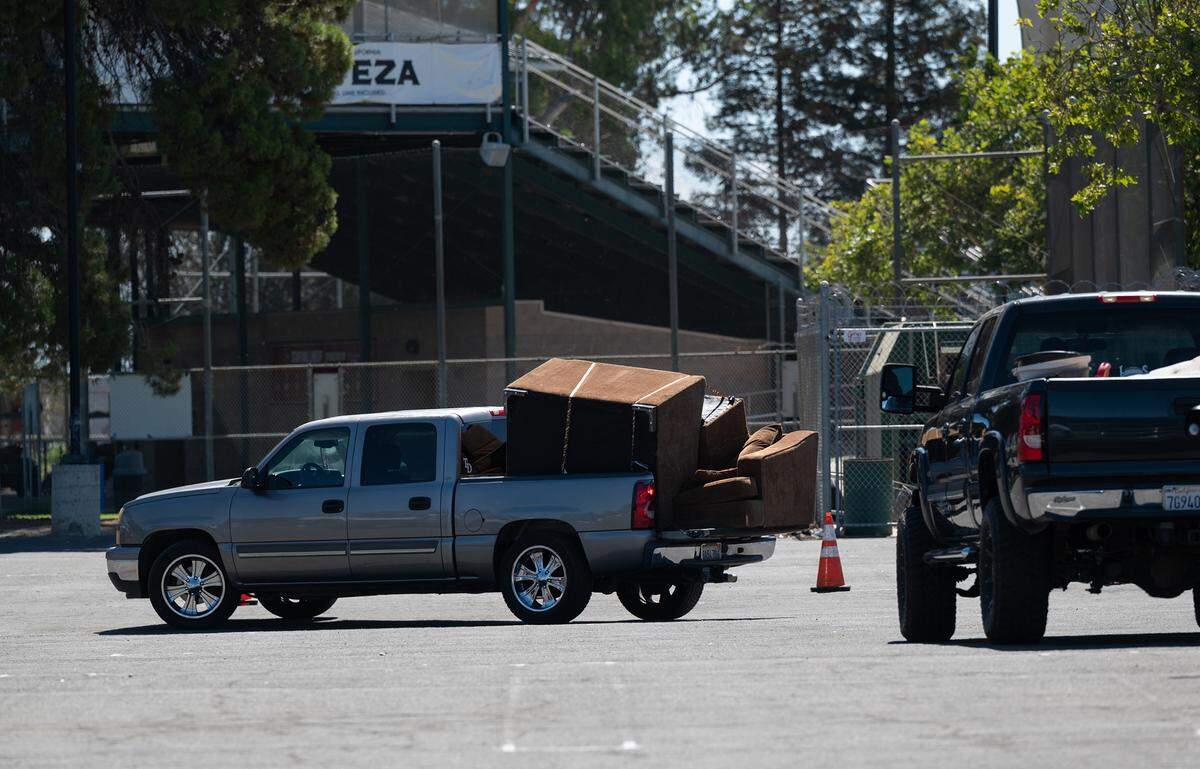 Modesto residents lined up to dispose of household items during a Modesto city sponsored trash day at John Thurman Field in Modesto, Calif., on Saturday, June, 25, 2022.