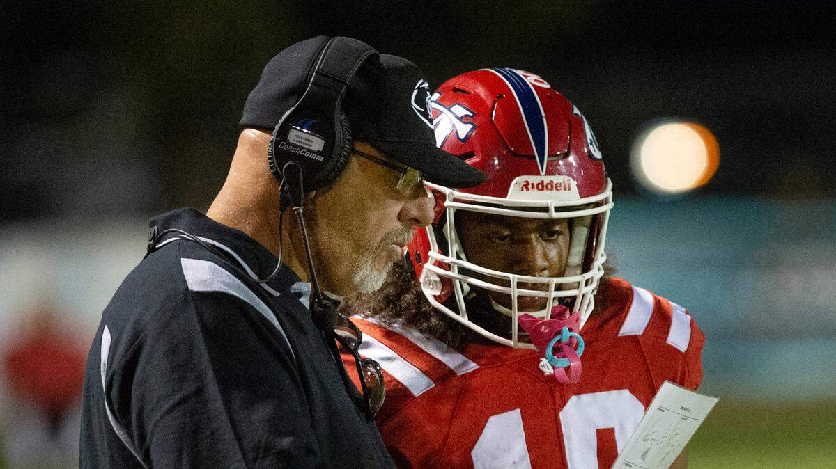 Modesto Christian head coach Jerry Grimshaw talks with quarterback Ross Widemon during the Trans Valley League game with Modesto Christian at Modesto Christian High School in Salida, Calif., Thursday, September 29, 2022.