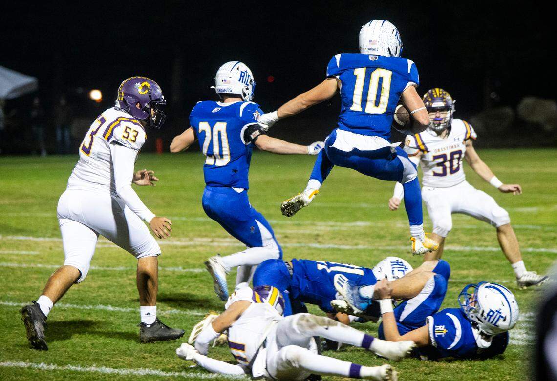 Ripon Christian’s Brady Grondz (10) leaps over a pile of defenders in the Sac-Joaquin Section Division VII-A Championship against Orestimba at Ripon Christian High School on Friday, Nov. 17, 2023.