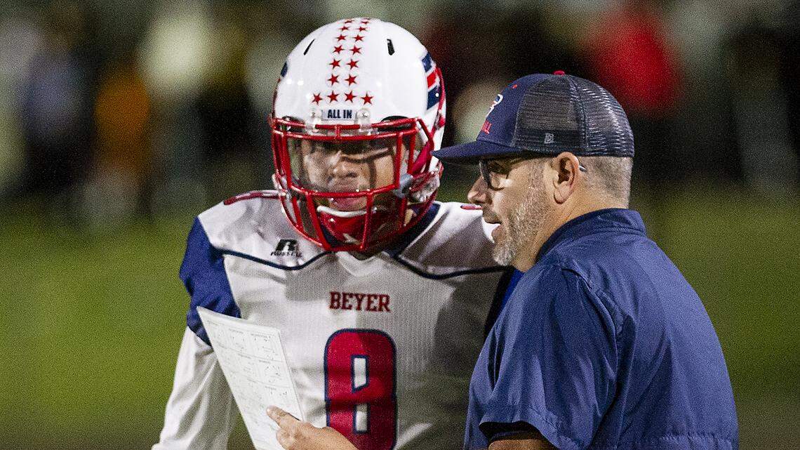 Beyer coach Greg Bockman, right, talks with Sam Betancourt during the Western athletic Conference game with Davis at Gregori High School in Salida, Calif., Thursday, Oct. 17, 2019.