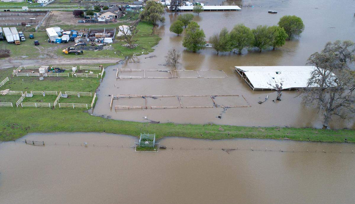 Horse stables on Old Las Palmas Avenue are underwater after the San Joaquin River flooded it banks in Patterson, Calif., Wednesday, March 22, 2023.