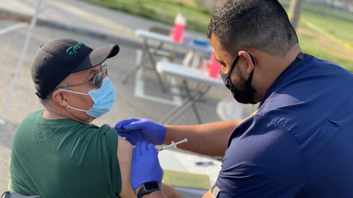 Jesus Villa, a promoter or community outreach worker, receives his first dose of the Moderna COVID-19 vaccine at mobile clinic site at King-Kennedy Center in West Modesto on Feb. 8, 2021.