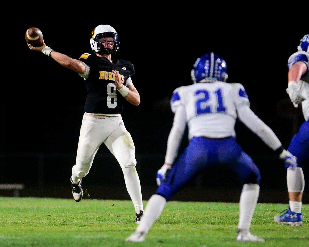 Hughson quarterback Robert McDaniel (8) throws a deep pass during a 2024 CIF Sac-Joaquin Section Division V Playoff game between Hughson High School and El Dorado High School at Hughson High School in Hughson California on November 15, 2024. Hughson won the game 28-6.