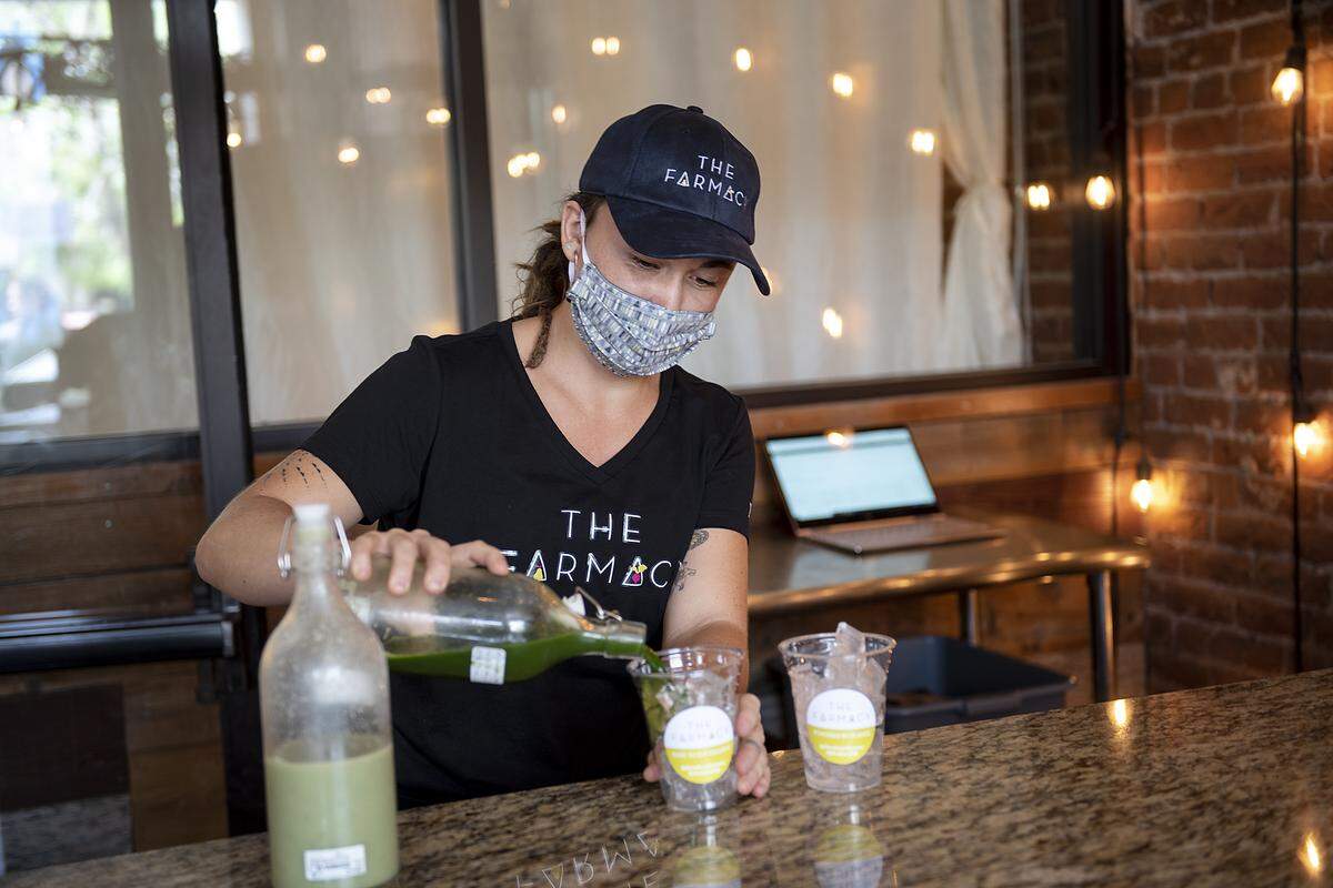 Brianna Gunnarson prepares a kale martini and honeydew wheatgrass margarita at the Farmacy, a new plant-based restaurant, in Modesto, Calif., on Thursday, May 14, 2020.