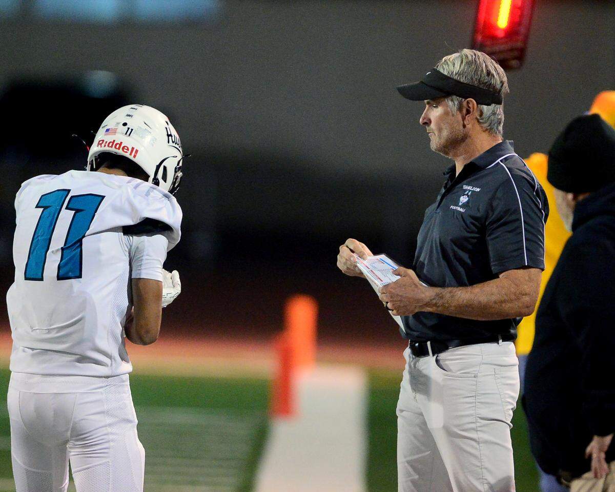 Sheldon Head Coach Chris Nixon talks with receiver Chiron Pham (11) during a CIF Sac-Joaquin Section Football Division I playoff game between Turlock High School and Sheldon High School at Turlock High School in Turlock, California on Nov. 3, 2023.