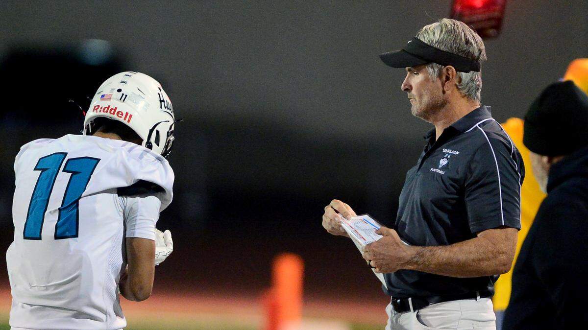 Sheldon Head Coach Chris Nixon talks with receiver Chiron Pham (11) during a CIF Sac-Joaquin Section Division I playoff game against Turlock in 2023.