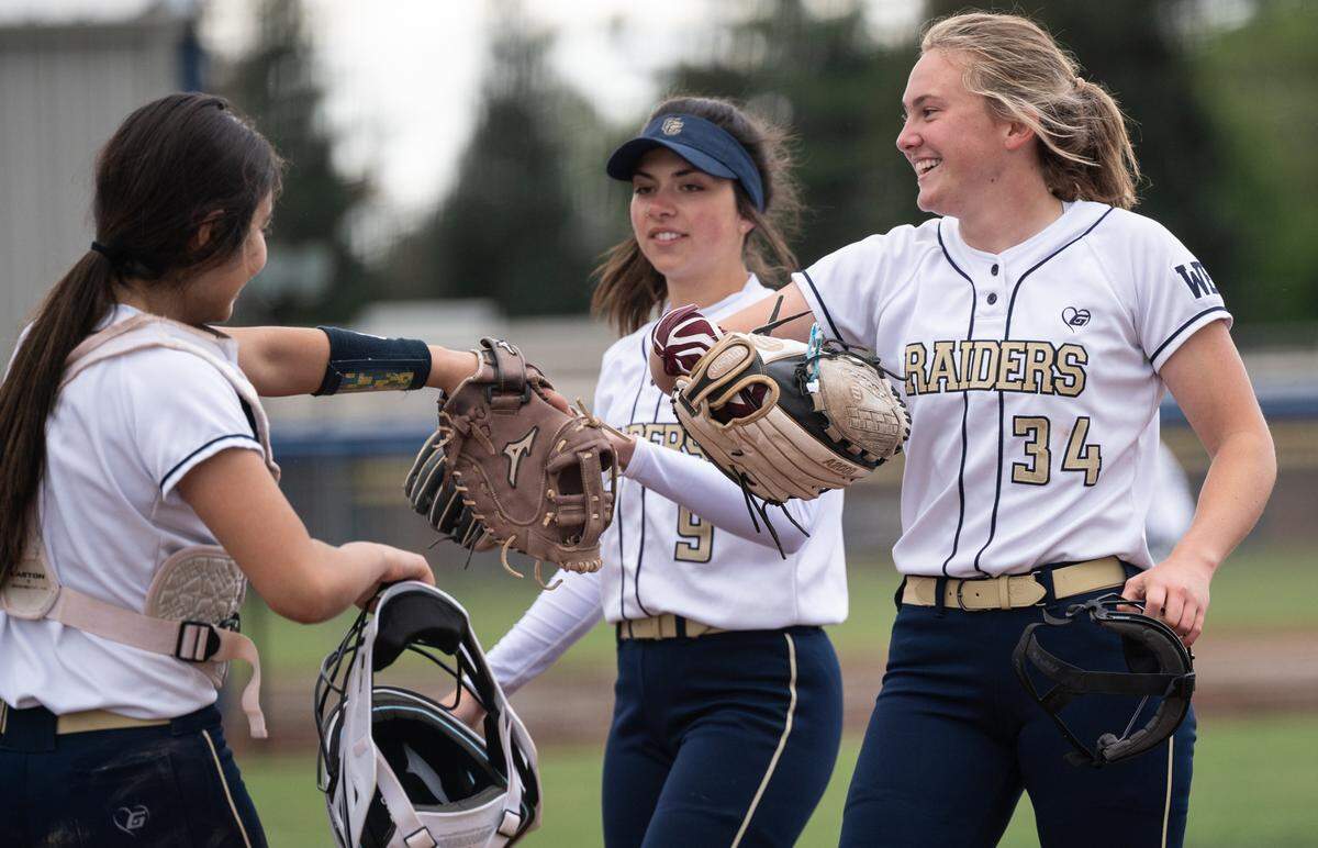 Central Catholic pitcher Randi Roelling and catcher Noelany Ramirez, left, and Brooke Miranda, middle, walk off the field after a no-hit inning during the Valley Oak League game with Manteca at Central Catholic High School in Modesto, Calif., on Monday, March 28, 2022. Central Catholic won the game 1-0.