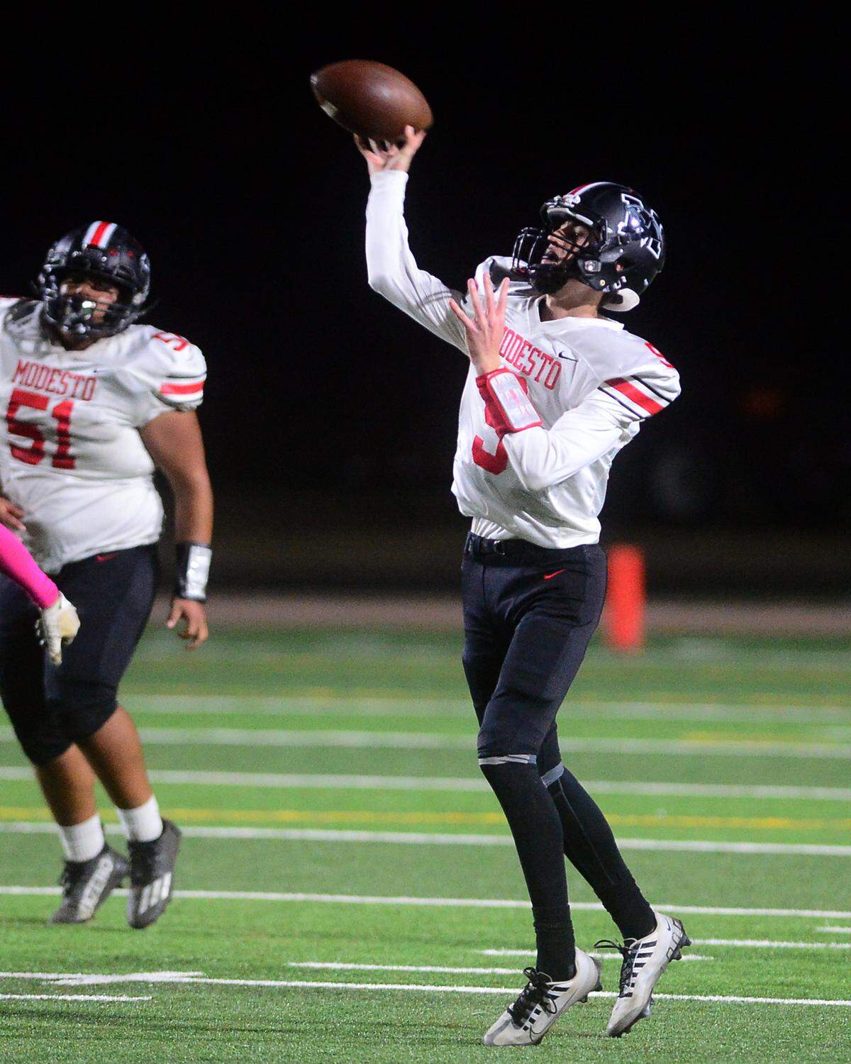Modesto High quarterback Eli McCabe throws a deep pass during a game against Enochs at Johansen High School in Modesto, Calif., on Oct. 28, 2022.