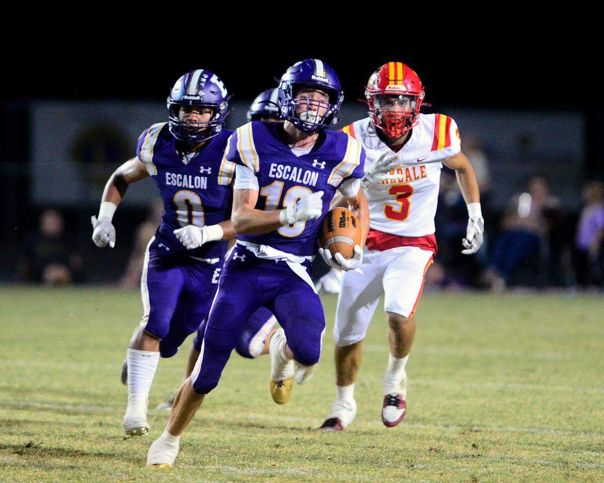 Escalon receiver Chase Cummings (18) sprints away from an Oakdale defender on a kick return during a game between Escalon High School and Oakdale High School in Escalon, Calif. on Sept. 6, 2024. Oakdale won the game 21-20 in overtime.