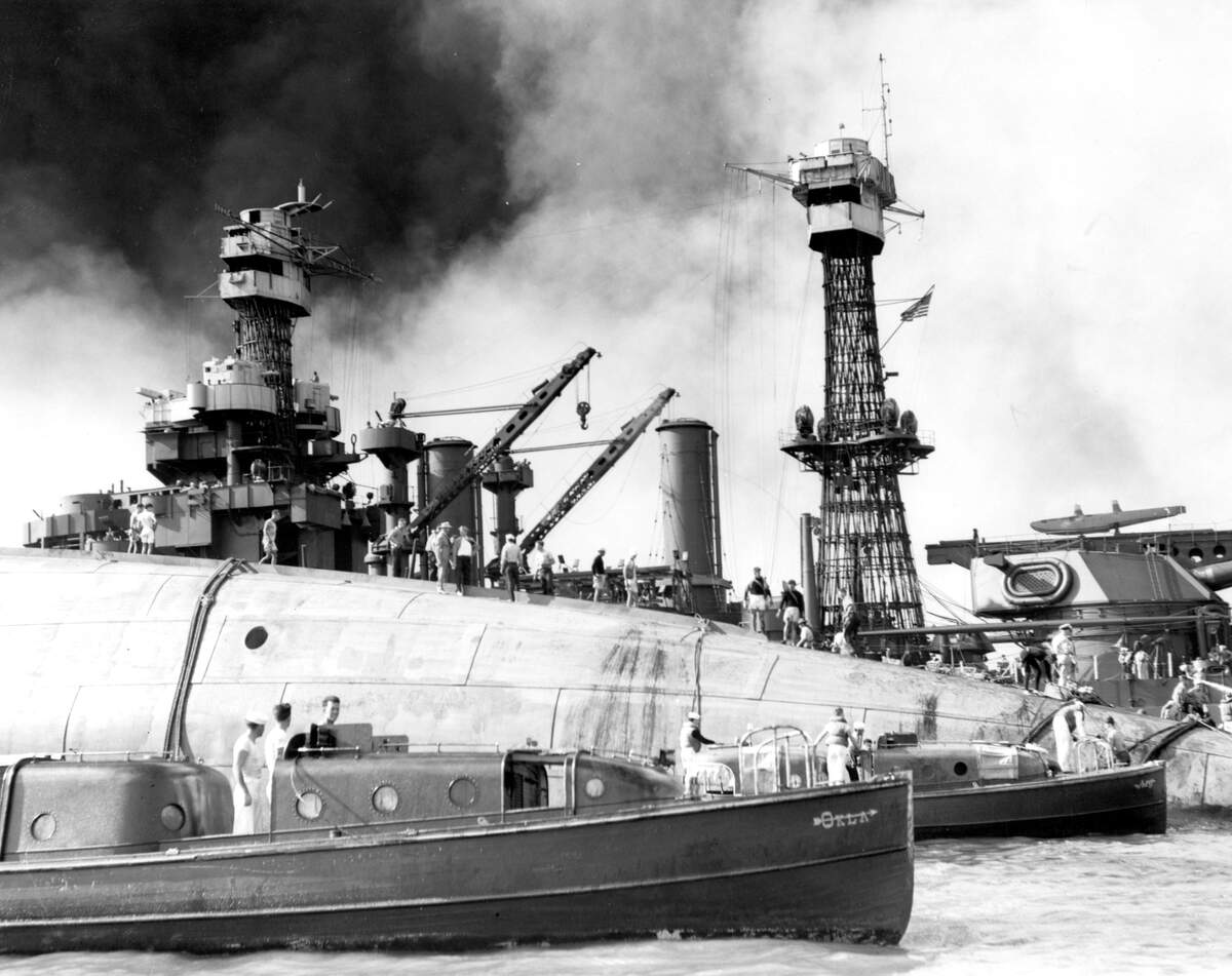 Navy personnel try to rescue sailors on the USS Oklahoma, including Raymond Camery of Modesto, on Dec. 7, 1941.