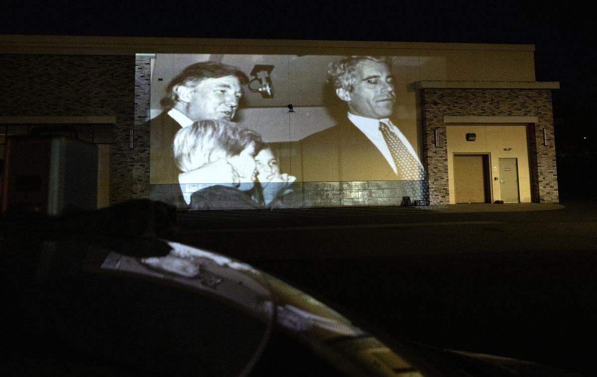 Local activists have started using a projector to display protest messages on buildings as a form of silent visual protest. Photographed on Briggsmore Avenue in Modesto, Thursday, July 24, 2025.