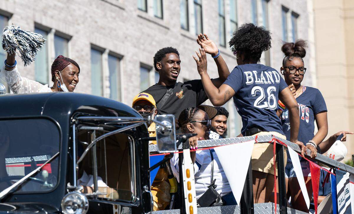 Dallas Cowboys player and Central High School graduate Daron Bland waves to the crowd during the Independence Day Parade in Modesto, Calif., Tuesday, July 4, 2023.