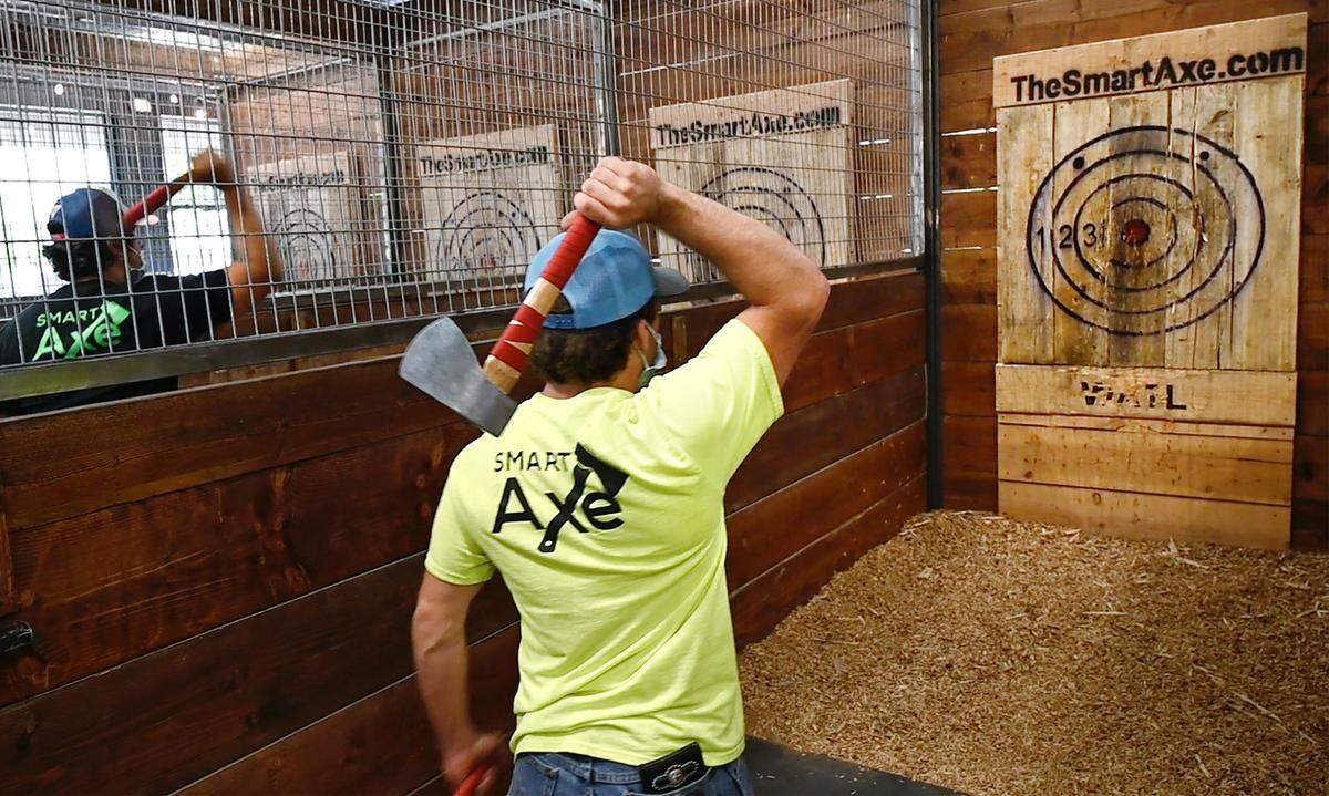 Blake Albino demonstrates how to throw an ax at Smart Axe ax-throwing bar in Modesto, Calif., on Thursday, May 13, 2021.
