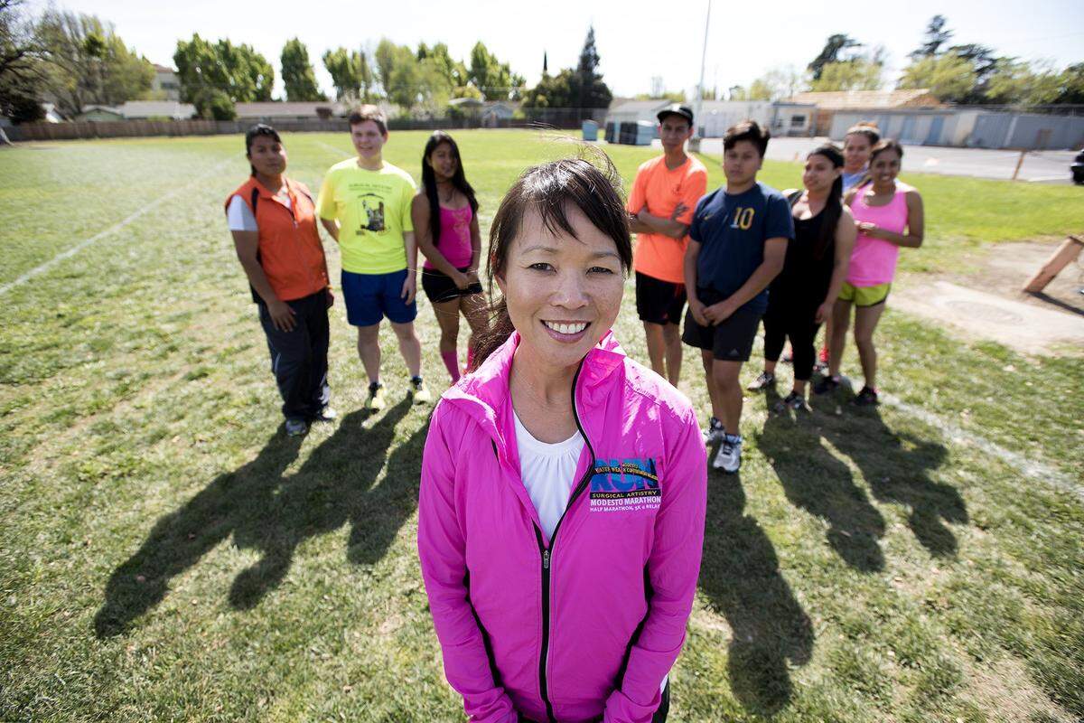 Vickie Chu-Hermis, race director for the Modesto Marathon, is pictured with the Downey High chapter of Teens Run Modesto at the Modesto school in March 2015.