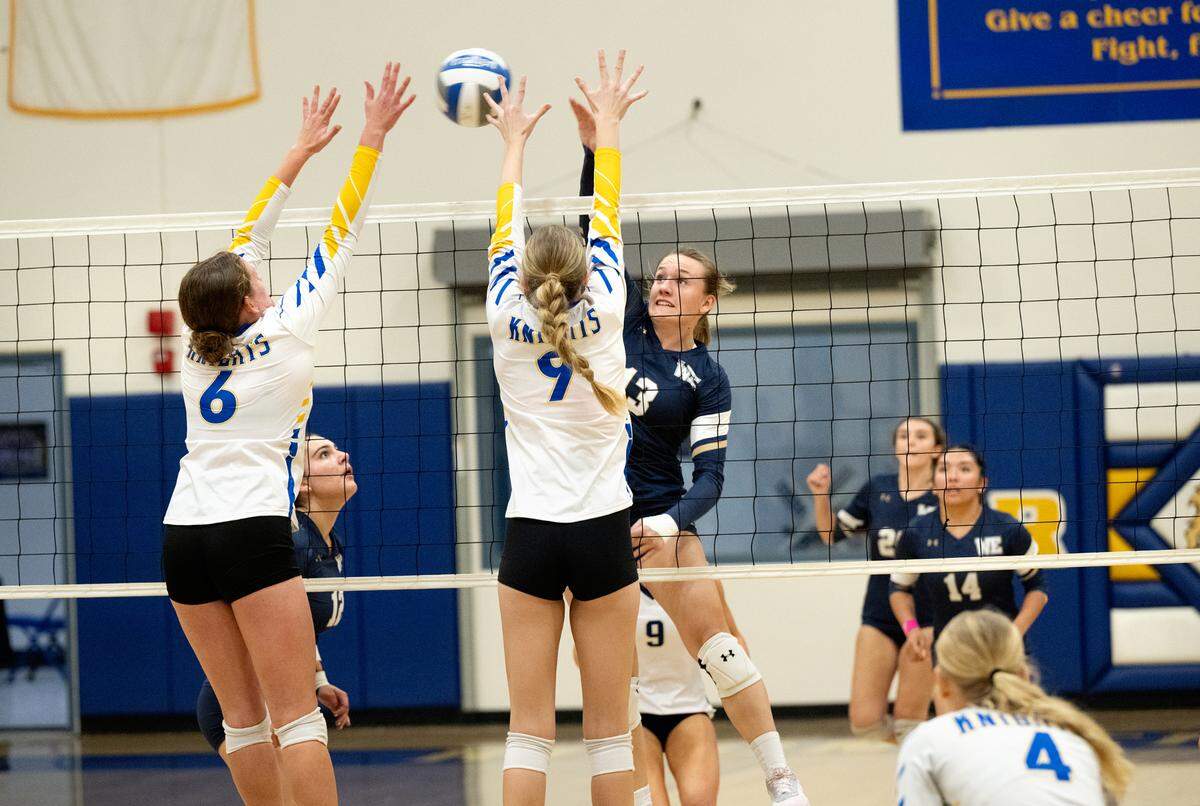 Central Catholic’s Marie Wildenberg (13) spikes the ball as Ripon Christian’s Morgan Schenk (6) and Brynn Bohn (9) defend at the net during the Sac-Joaquin Section Division III quarterfinal playoff match at Ripon Christian High School in Ripon, Thursday, Oct. 31, 2024.