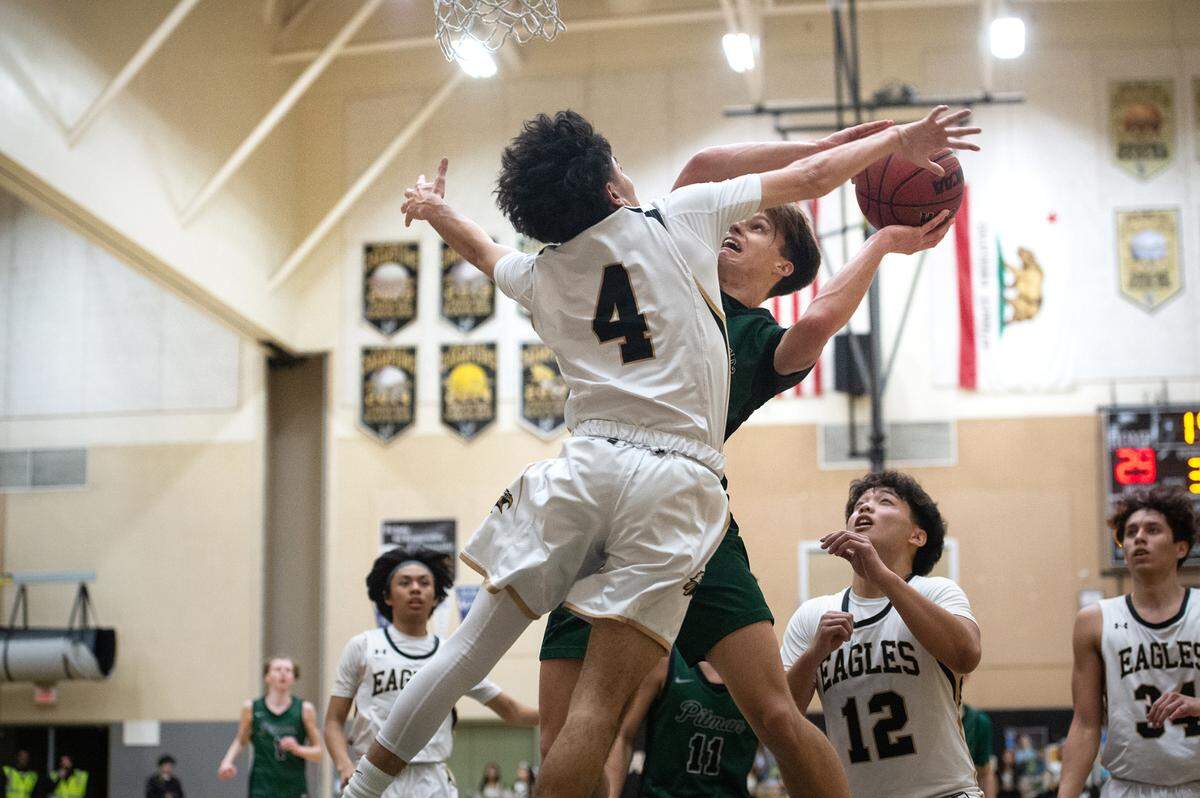 Pitman’s Seth Vink scores as Enochs’ Xavier Rosas (4) defends during the Central California Athletic League game at Enochs High School in Modesto, Calif., Friday, Feb. 10, 2023.