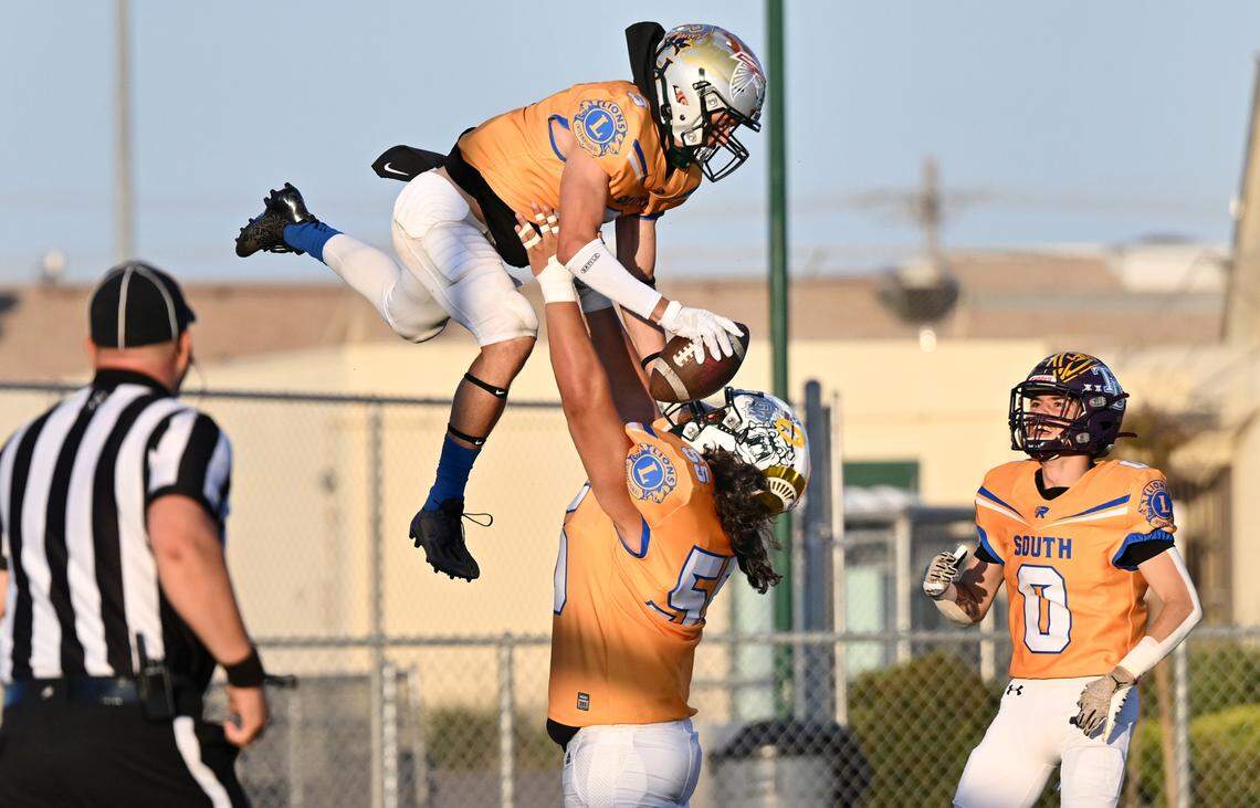 South’s Fermin Villegas lifts up teammate Joey Stout (3) to celebrate a touchdown during the Central California Lions All-Star Football Game at Tracy High School in Tracy, Calif., Saturday, June 24, 2023. The South won the game 38-13.