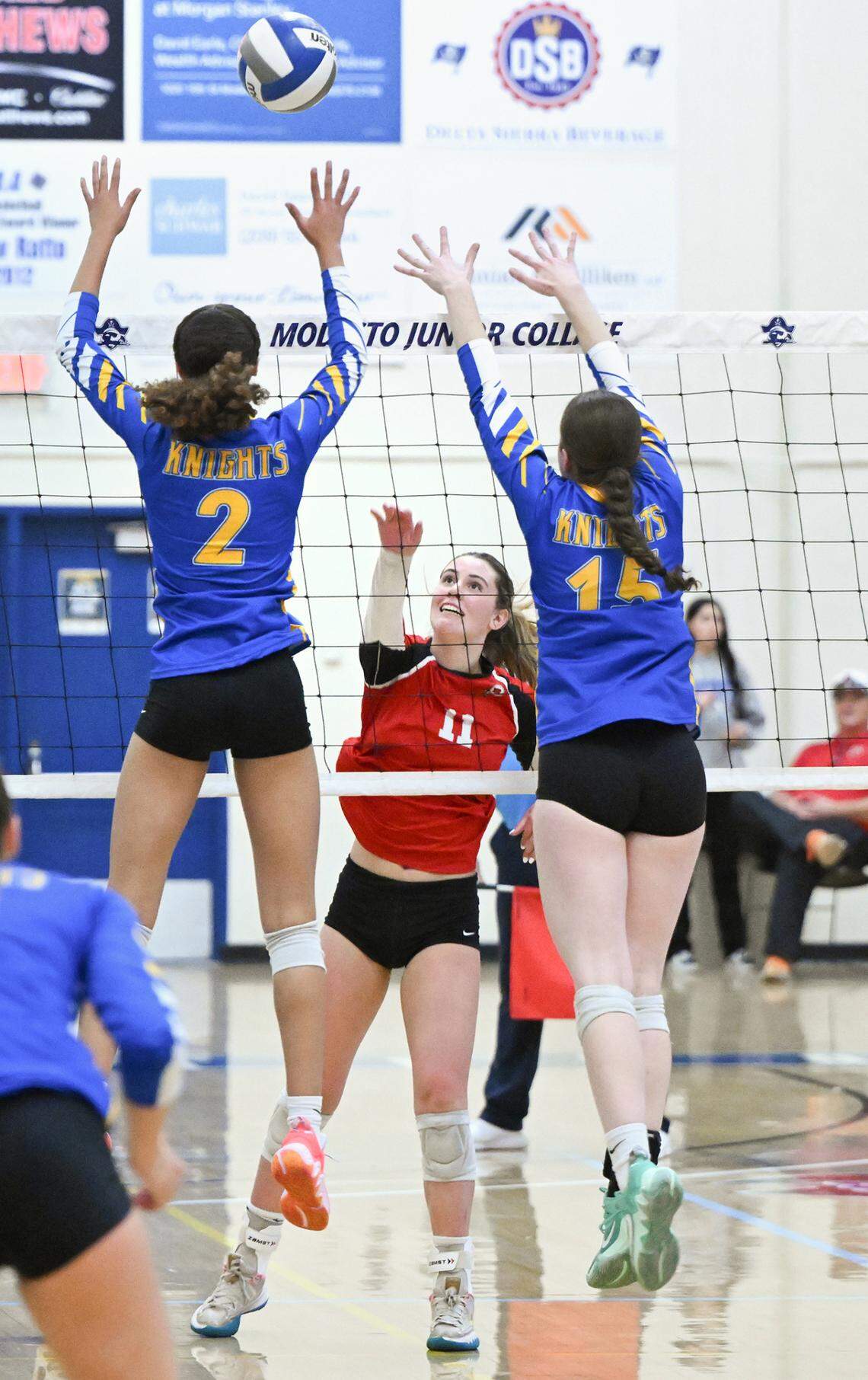 Ripon’s Adriana Dorn floats the ball over Ripon Christian’s Sydney Hoffman (2) and Maddie Yonker (15) during the Sac-Joaquin Section Division IV championship match at Modesto Junior College in Modesto, Calif., Saturday, Nov. 4, 2023. Ripon Christian won the match 3-0.