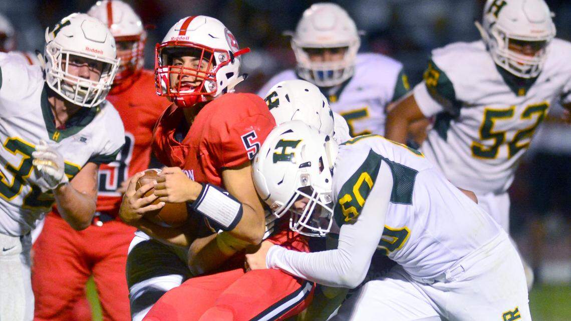 Ripon quarterback Ryan Daggett (5) is stopped by Hilmar’s Brennan Mason (60) during a game between Ripon and Hilmar at Ripon High School in Ripon CA on September 14, 2018.

