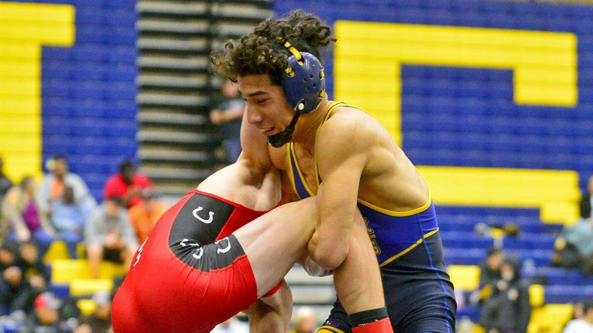Turlock High School’s Adrian Heras lifts his opponent before winning the 126 championship match during the CIF Sac-Joaquin Section Division II Wrestling Tournament at Gregori High School in Modesto, CA on February 9, 2019.
