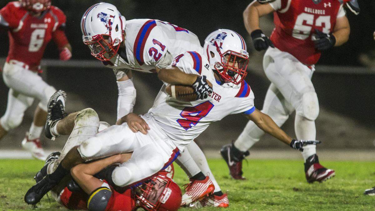 Gabe Ruiz, 4, gets taken down by a Ceres High defender. Beyer took on Ceres High at Ceres on Friday, Sept. 21, 2018.