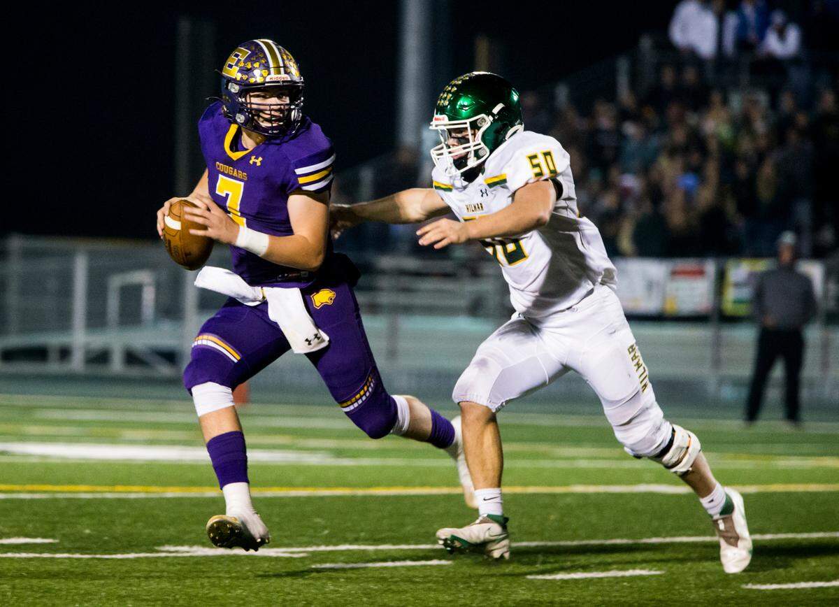 Escalon Highs Donovan Rozevink, 7, looks up field as Hilmar Highs Nicholas Vitorino, 50, closes in. Escalon High School took on Hilmar High football during the 2021 CIF Sac-Joaquin Football Playoffs - Division V at Saint Mary’s High School in Stockton, Ca. Escalon came out on top as the champions with a 20-13 win over Hilmar.