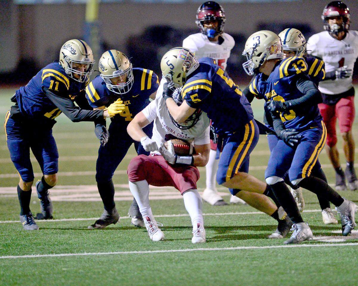 Laguna Creek receiver Ryan Eddy (2) gets taken down by multiple Turlock defenders during a Division 1 CIF San-Joaquin Section playoff game between Turlock High School and Laguna Creek High School at Turlock High School in Turlock California on November 8, 2024. Turlock won the game 48-12.