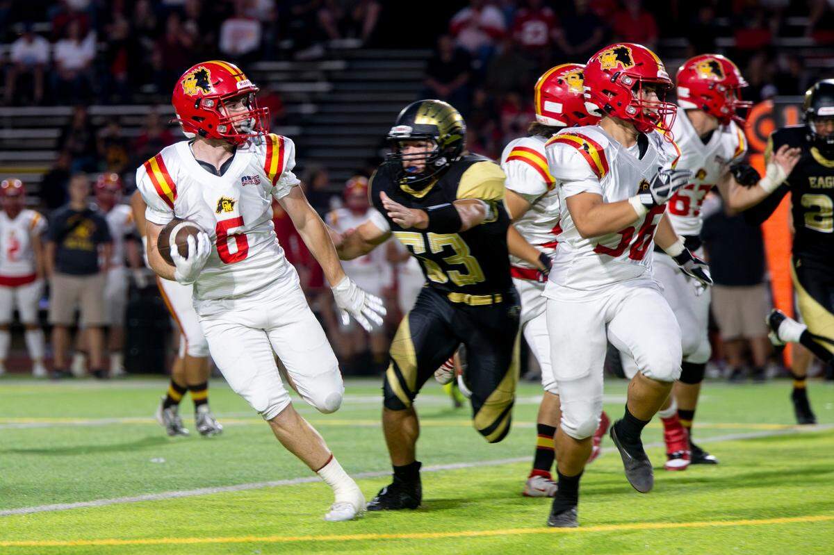 Chase Lopez, 6 of Oakdale High works his way around the line as Enochs defenders close in during the Oakdale vs Enochs game Friday Sept. 22, 2023
